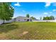 The expansive backyard features a privacy fence, and green grass at 27 Juniper Dr, Ocala, FL 34480