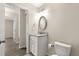 Bathroom featuring granite counters, an oval mirror, and decorative lighting at 27 Juniper Dr, Ocala, FL 34480