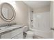 Well-lit bathroom featuring granite counters, decorative mirror and shower and tub combo at 27 Juniper Dr, Ocala, FL 34480
