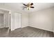Spacious bedroom showcasing wood-look flooring, ceiling fan, and closet at 27 Juniper Dr, Ocala, FL 34480