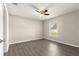 Cozy bedroom featuring wood-look flooring, neutral walls, and a ceiling fan at 27 Juniper Dr, Ocala, FL 34480