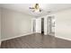 Bright bedroom featuring wood-look flooring, and access to an en-suite bathroom and laundry at 27 Juniper Dr, Ocala, FL 34480