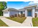 Beautiful home with an attached garage, complemented by green landscaping, creating a serene curb appeal at 27 Juniper Dr, Ocala, FL 34480