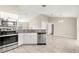 Well-equipped kitchen with stainless steel appliances, granite countertops, and sleek white cabinetry at 27 Juniper Dr, Ocala, FL 34480
