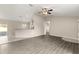 Open-concept living space with wood-look flooring and a breakfast bar looking into the kitchen at 27 Juniper Dr, Ocala, FL 34480