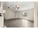 Bright living room featuring wood-look flooring, neutral walls, and a ceiling fan at 27 Juniper Dr, Ocala, FL 34480