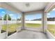 Screened back patio with great natural light and a view of the backyard at 27 Juniper Dr, Ocala, FL 34480