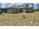 Expansive backyard showcasing the home's rear exterior, complemented by a spacious lawn at 2730 Sw 173Rd Place Rd, Ocala, FL 34473
