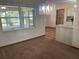 Dining room features a stylish chandelier, a window, and carpet flooring at 2730 Sw 173Rd Place Rd, Ocala, FL 34473
