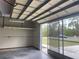 Open garage showcasing a screened door, providing ventilation and natural light to the space at 2730 Sw 173Rd Place Rd, Ocala, FL 34473