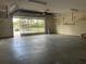Bright and airy garage featuring an open door and spacious concrete floors, providing ample parking and storage at 2730 Sw 173Rd Place Rd, Ocala, FL 34473