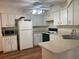 Charming kitchen with white cabinets, wood floors, and modern appliances at 2730 Sw 173Rd Place Rd, Ocala, FL 34473