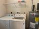 Spacious laundry room with washer, dryer, and shelving for extra storage at 2730 Sw 173Rd Place Rd, Ocala, FL 34473