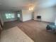 Inviting living room with neutral carpet, ceiling fan, and ample natural light for a comfortable atmosphere at 2730 Sw 173Rd Place Rd, Ocala, FL 34473