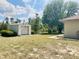 Exterior of a metal shed on a verdant lot with a blue sky at 2730 Sw 173Rd Place Rd, Ocala, FL 34473