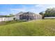 Lush backyard with a screened-in pool area and white picket fence, perfect for Gathering gatherings at 4020 Se 23Rd St, Ocala, FL 34471