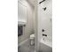 Bathroom featuring a window, toilet, and tub/shower with white subway tile and black fixtures at 4020 Se 23Rd St, Ocala, FL 34471