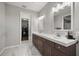 Elegant bathroom featuring double sinks, vanity, and access to the walk-in closet at 4020 Se 23Rd St, Ocala, FL 34471
