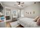 Bedroom featuring wood floors, a white bed, and vanity with a doorway leading to a bathroom at 4020 Se 23Rd St, Ocala, FL 34471