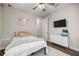 Bedroom featuring wood floors, a white bed, and white dresser with a TV on the wall at 4020 Se 23Rd St, Ocala, FL 34471