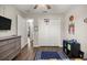 bedroom featuring wood floors, closet and a dresser with sports themed decor on the walls at 4020 Se 23Rd St, Ocala, FL 34471