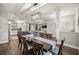 Open-concept dining area with modern lighting and seamless flow to the kitchen and living room at 4020 Se 23Rd St, Ocala, FL 34471