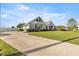 Spacious driveway leading to a lovely single-story home with lush green lawn at 4020 Se 23Rd St, Ocala, FL 34471
