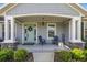 Inviting front porch with seating and a charming entrance with a wreath and welcome sign at 4020 Se 23Rd St, Ocala, FL 34471