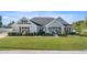 Charming single-story home featuring a well-manicured lawn and inviting front porch at 4020 Se 23Rd St, Ocala, FL 34471