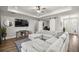 Bright living room featuring tray ceilings, fan, barn doors, and comfortable neutral sectional at 4020 Se 23Rd St, Ocala, FL 34471