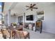 Cozy covered patio featuring a full outdoor kitchen, dining area, and comfortable seating, perfect for relaxing at 4020 Se 23Rd St, Ocala, FL 34471