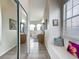 Hallway to bathroom featuring tile floors, a mirrored sliding door closet and a vanity area at 4033 Ne 15Th Court Rd, Ocala, FL 34479