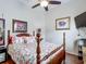 Charming bedroom features a wood bed frame, floral bedding, and a mounted TV for relaxation at 4033 Ne 15Th Court Rd, Ocala, FL 34479