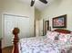 Cozy bedroom with a floral comforter and wood furniture, adjacent to a mirrored closet at 4033 Ne 15Th Court Rd, Ocala, FL 34479
