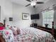 Bright bedroom showcasing a bed, dark wood furniture, and a window with blinds for a cozy retreat at 4033 Ne 15Th Court Rd, Ocala, FL 34479