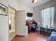 Bedroom featuring wood floors, a mounted TV, a desk area, and closet at 4033 Ne 15Th Court Rd, Ocala, FL 34479