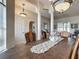 Elegant dining room with decorative chandelier lighting, columns, and large table at 4033 Ne 15Th Court Rd, Ocala, FL 34479