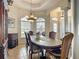 Elegant dining room with chandelier lighting, columns, large window, and decorative trim at 4033 Ne 15Th Court Rd, Ocala, FL 34479