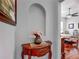 Elegant entryway featuring a decorative table, vase with flowers, and a glimpse into a room with hardwood floors at 4033 Ne 15Th Court Rd, Ocala, FL 34479