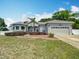 Charming single-story home featuring a two-car garage, manicured lawn, and a well-maintained landscape at 4033 Ne 15Th Court Rd, Ocala, FL 34479