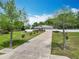 Exterior of home with long driveway and well-manicured lawn and landscaping at 4033 Ne 15Th Court Rd, Ocala, FL 34479