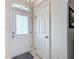 Bright foyer featuring a decorative glass front door and a convenient coat closet at 4033 Ne 15Th Court Rd, Ocala, FL 34479