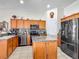 Kitchen showcasing a stylish island, granite countertops, and stainless steel appliances for a modern cooking experience at 4033 Ne 15Th Court Rd, Ocala, FL 34479