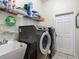 Functional laundry room equipped with modern washer and dryer units and convenient overhead shelving at 4033 Ne 15Th Court Rd, Ocala, FL 34479