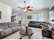 Spacious living room with a ceiling fan and comfortable seating arrangements perfect for relaxation and entertaining guests at 4033 Ne 15Th Court Rd, Ocala, FL 34479