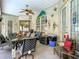 Inviting covered patio with a ceiling fan and colorful decor, perfect for outdoor relaxation and entertaining at 4033 Ne 15Th Court Rd, Ocala, FL 34479