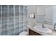 Well-maintained bathroom with modern vanity, patterned shower curtain, and ample lighting at 4188 Sw 53Rd Lane Rd, Ocala, FL 34474