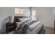 Cozy bedroom features a queen bed with a blue and white patterned cover, bedside tables, and soft natural light at 4188 Sw 53Rd Lane Rd, Ocala, FL 34474