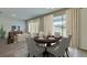 Elegant dining area with a round table, six chairs, and sliding glass doors leading to the outdoor space at 4188 Sw 53Rd Lane Rd, Ocala, FL 34474