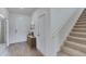 Inviting foyer with wood-look tile flooring, staircase, and a decorative table, creating a welcoming entrance at 4188 Sw 53Rd Lane Rd, Ocala, FL 34474